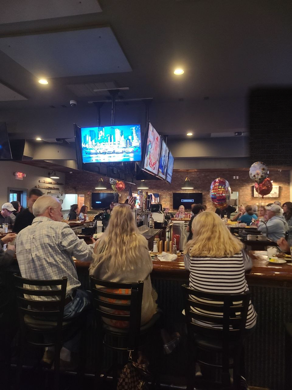 Guests watching the screens at The Chapter House bar
